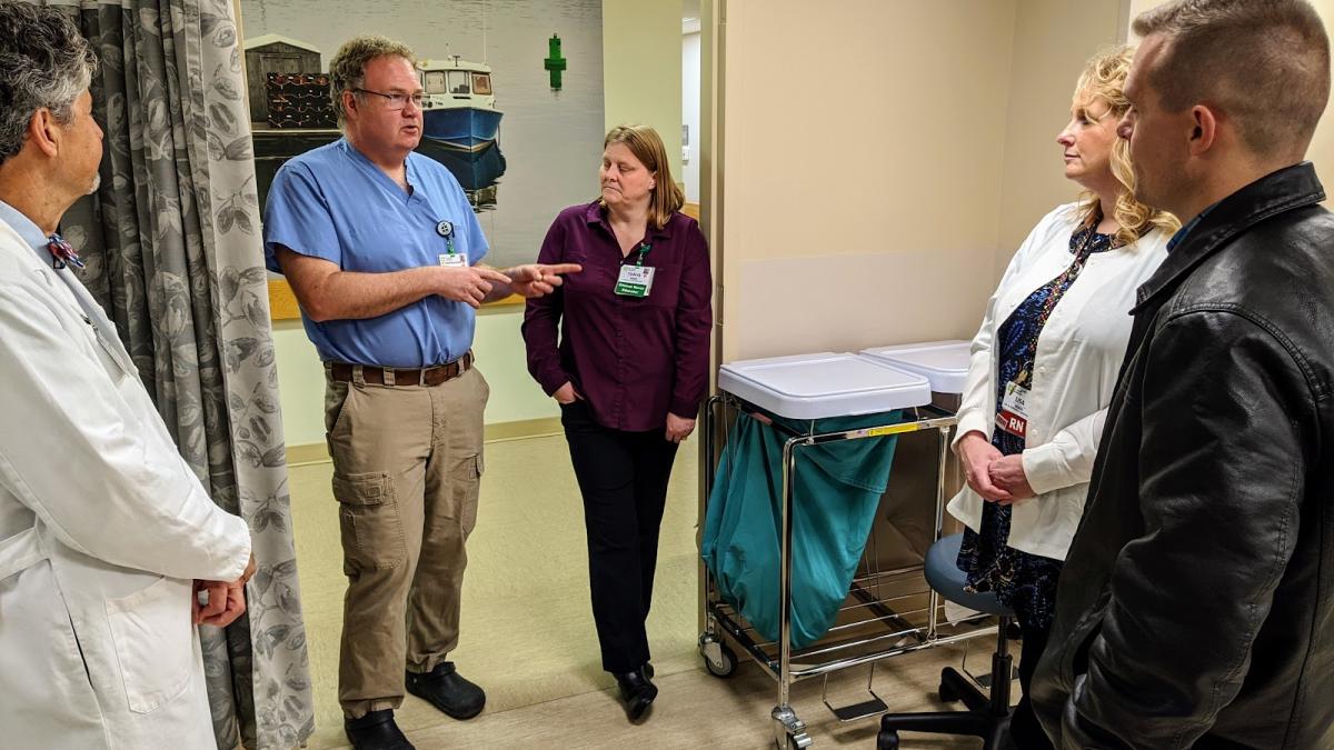Congressman Golden speaking with constituents at a hospital.