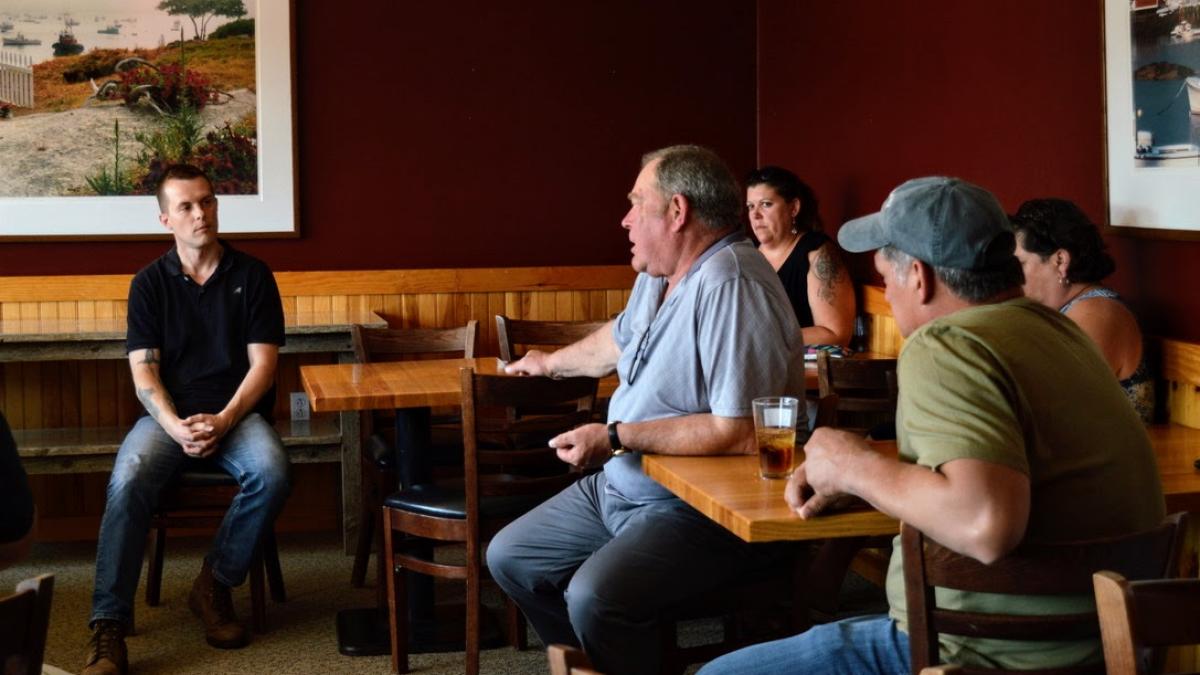 Congressman Golden sits down and speaks with people.