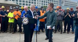 Congressman Jared Golden (ME-02), right, greets Congressman Stephen F. Lynch (MA-08) at Boston Ship Repair on Tuesday, June 17, 2025. Behind them are Congressman Joe Courtney (CT-02) and members of the International Association of Machinists.