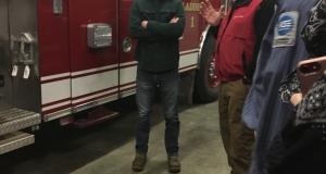 Congressman Jared Golden stands in front of a firetruck.