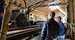 Congressman Golden looks at a large saw.