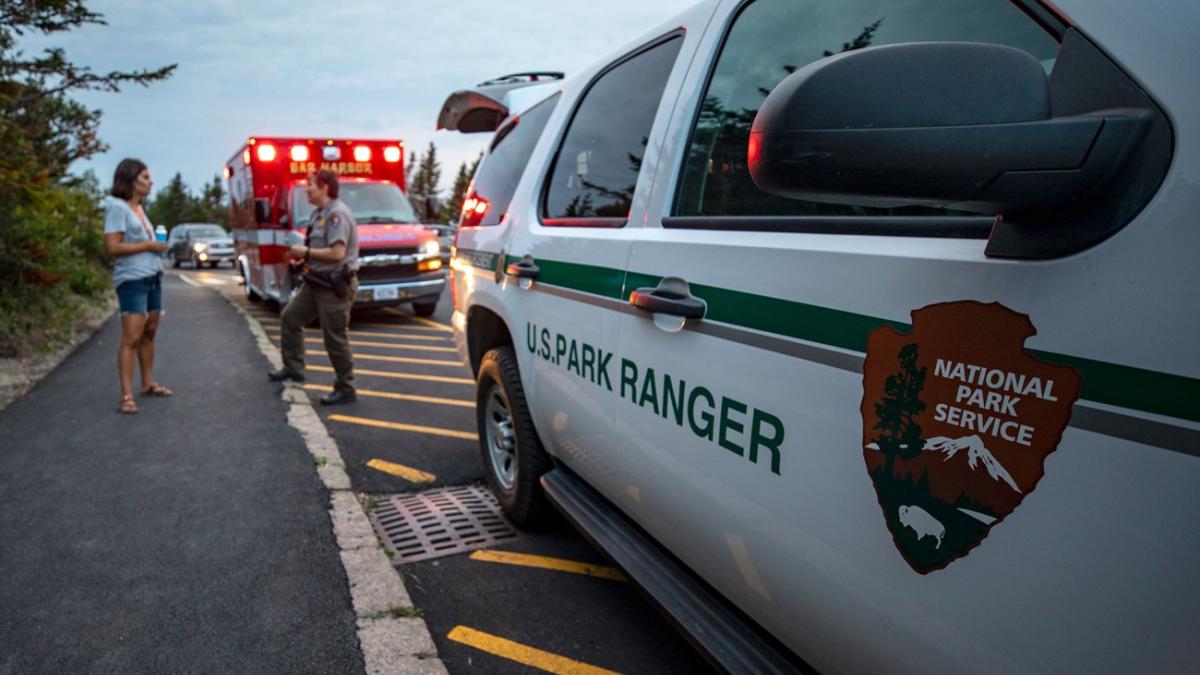 A Park Ranger consults with a park visitor while responding to a medical call on top of Cadillac Mountain while on duty in Acadia National Park, ME. Photo by: Will Newton/Friends of Acadia/NPS