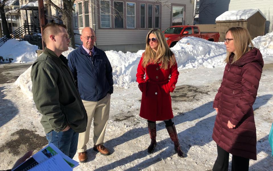 Congressman Jared Golden speaks with constituents and a member of the SBA.