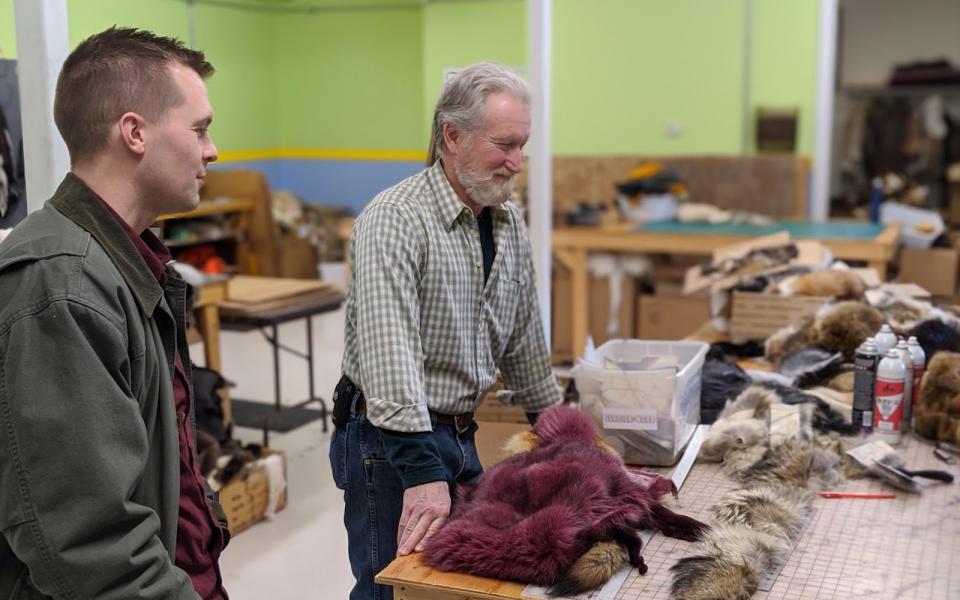 Congressman Jared Golden looks at furs.