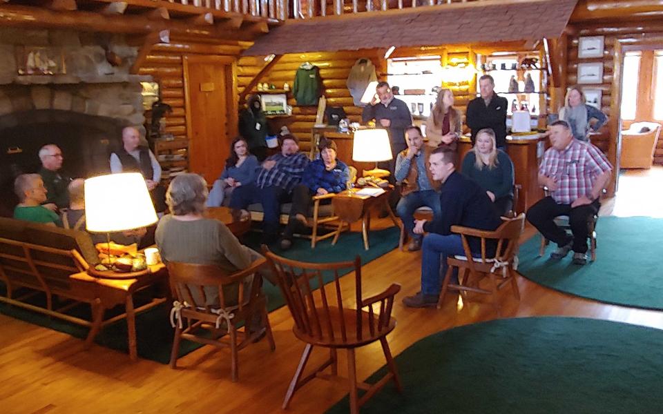 Congressman Jared Golden speaks in a cabin/lodge.