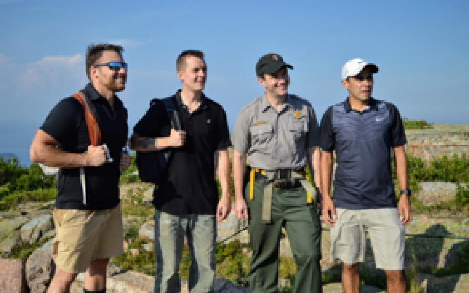 Congressman Jared Golden smiling on a hike.